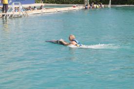 Click to enlarge image Someone riding the belly of Copernicus - Ever wonder what it is like to swim with a Dolphin? - Dolphin Discovery Grand Cayman