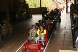 Wagon Train in loading area. Notice no front wall at the head. Riders have a clear view DOWN the 81 degree drop. Wagon Train in loading area. Notice no front wall at the head. Riders have a clear view DOWN the 81 degree drop. - Silver Dollar City - Outlaw Run - A New Roller Coaster that is as Exciting as it Seems!