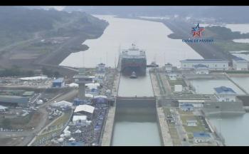 Click to enlarge image Cosco Shipping Panama approaches the NEW Cocoli Locks of the expanded Panama Canal.. the first largest ship to pass through the new locks!  Here the crowds for the celebration of this passage can be seen to the lower left side of the locks. There is a stage and stadium seating set up for the event! — at Panama Canal. - Panama Canal Expansion Inauguration - June 26, 2016