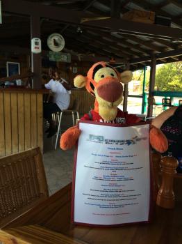 Click to enlarge image The menu. That is Captain Taiwo in the background. - TRC Boating in the British Virgin Islands - Part 3 of 5 - Lunch in Spanish Town at Mermaid's Dockside Bar and Grill