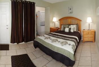 Click to enlarge image Bedroom with Laundry room in the background. There is also a closet out of frame to the left. - Treasure of a Condo for Rent in Destin, Florida - Tigger has his favorite Condo in Miramar Beach, Florida with a pool and only a block from a public beach!