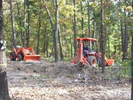 Click to enlarge image  - Breaking ground on the Earth Shelter House - It is official.. there is a hole!!