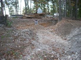 Click to enlarge image - Breaking ground on the Earth Shelter House - It is official.. there is a hole!!