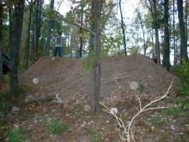 Click to enlarge image - Breaking ground on the Earth Shelter House - It is official.. there is a hole!!