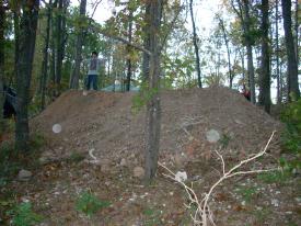 Click to enlarge image  - Breaking ground on the Earth Shelter House - It is official.. there is a hole!!